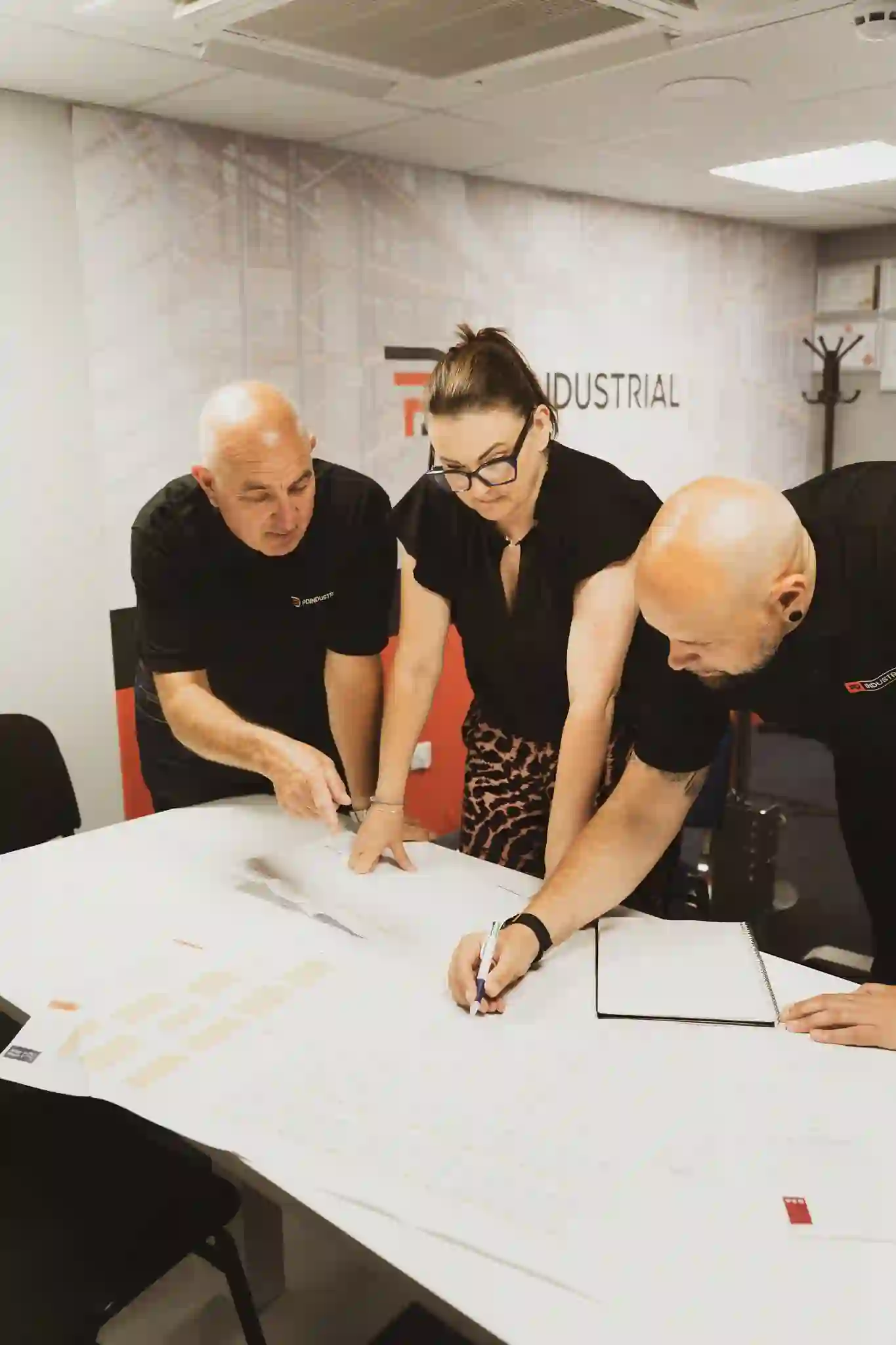 PD Industrial team reviewing warehouse racking plans together